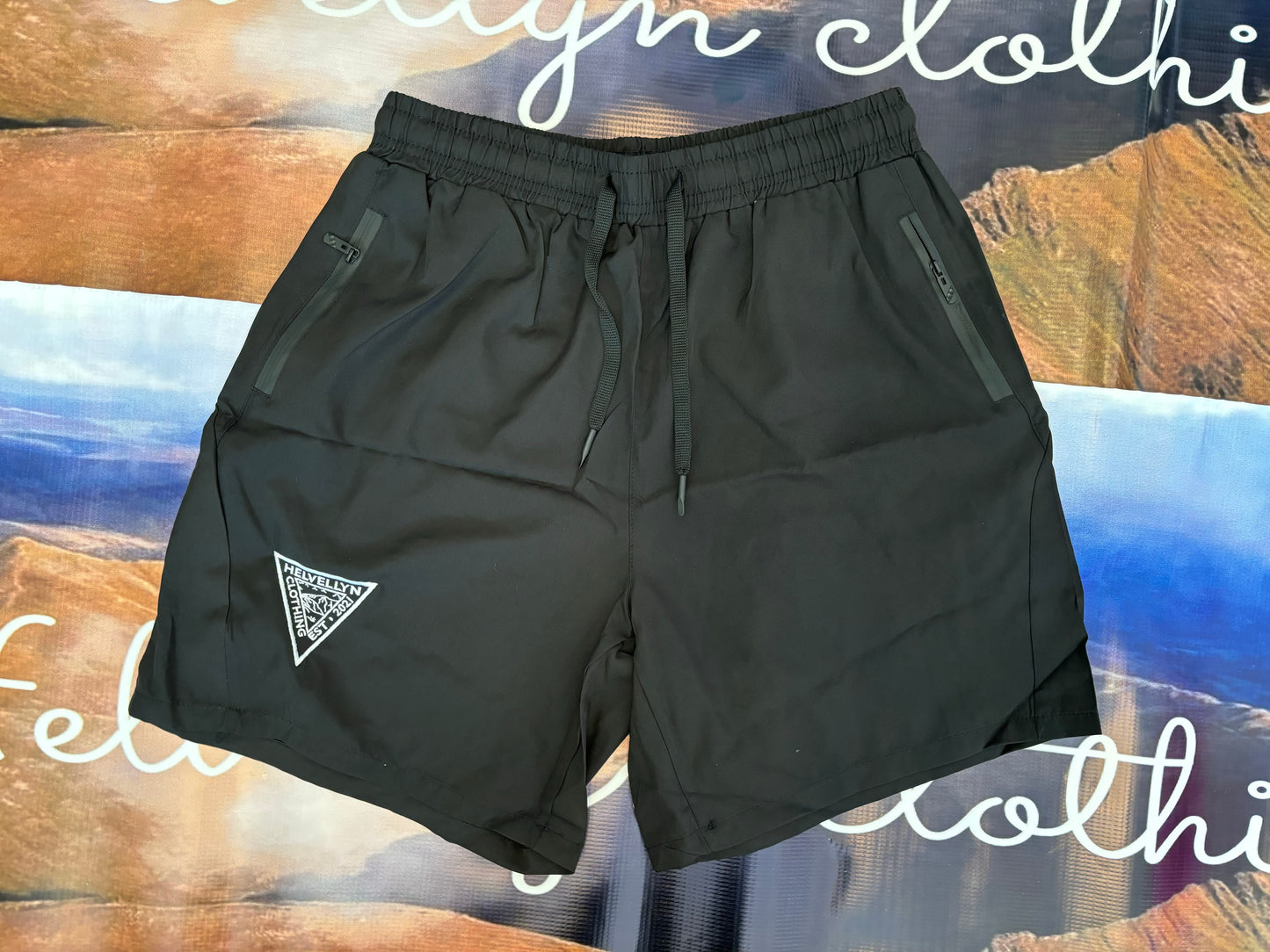 Black zip pocket shorts, white embroidered logo